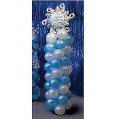 a tall blue and white balloon tower with snowflakes on it's top