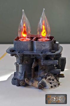 an old carbuke turned into a candle holder with two candles in the middle