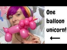 a woman with purple hair holding up a pink balloon in front of her face and the words one balloon unicorn on it