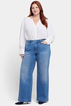 The Teresa Wide Leg Jeans in Plus Size with 1 1/2" Hems by NYDJ don’t just stand out—they steal the show. Their wide legs add instant polish to everything you pair them with. Our Lift Tuck® Technology is made to help you keep your shape, with a proprietary slimming panel with a patented criss-cross design that smooths and sculpts. Features five-pocket styling and a zip fly with button closure. Water Canyon is a vintage-inspired medium indigo wash with whiskering on the front hips, inseam chevrons and sanding on the front thighs, knees and seat. This jean is made with earth-friendly methods that result in reduced consumption of water, chemicals and/or energy. | NYDJ Women's Teresa Wide Leg Jeans In Plus Size in Water Canyon, Size: 22W | Denim Cross Design, Wide Legs, Petite Outfits, Earth Friendly, Jeans For Sale, In Water, Sanding, Jean Outfits, Wide Leg Jeans