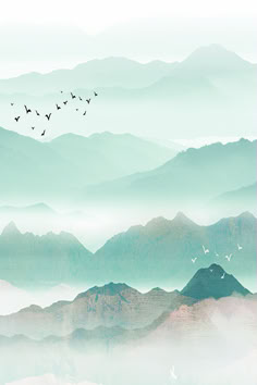 birds are flying over the mountains in the foggy sky, and there is no image here to provide a caption for