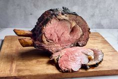 a piece of meat sitting on top of a wooden cutting board