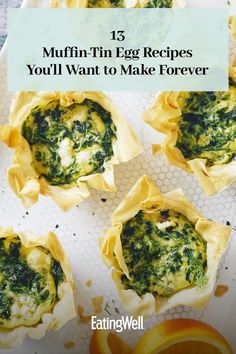 muffins filled with spinach and cheese on top of a white plate next to an orange