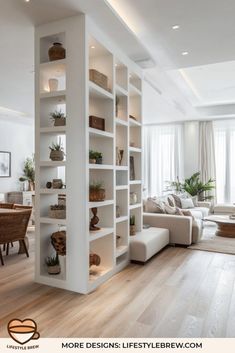 a living room filled with white furniture and lots of bookshelves on top of it