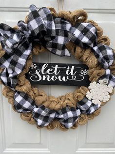 This is a handcrafted one of a kind wreath that I've created using a 16" wreath form and generously looping 100% jute burlap around it resulting in the final dimensions being approximately  18". I've then woven through a black and white buffalo plaid flannel ribbon and completed it with a coordinating ribbon bow at the top left corner. Lastly, I've then secured a black with white vinyl lettered LET IT SNOW sign to the center of the wreath. I've then given the wreath a white glitter snowflake on the right side for accent.This wreath could be displayed through the holidays as well as all winter long.  I've also placed a hanger on the back of the wreath for your ease and convenience of hanging. While all of my wreaths are constructed using quality materials, they are best kept in a covered ar Buffalo Plaid Christmas Wreath, Plaid Christmas Wreath, Snow Wreath, Let It Snow Sign, Buffalo Plaid Scarf, Buffalo Plaid Wreath, Christmas Wreath Diy, Plaid Wreath, Holiday Wreaths Christmas