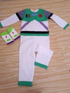 the toy story buzz lightyear costume is laying on the floor next to it's matching socks