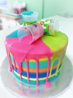 there is a colorful cake with icing on it