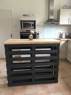 an island made out of pallets in a kitchen