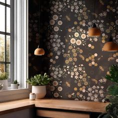 a room with flowers on the wall and potted plants in the window sill