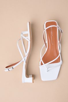 The Intentionally Blank Fifi Ice White Leather Strappy Slingback Low Heel Sandals pair to perfection with warm sunny days! Smooth genuine leather shapes these effortlessly chic sandals that feature a square footbed and a thong-style upper that flows into an asymmetrical strappy vamp. A trendy slingback strap sprouts from the sides and secures at the outstep with a shiny silver buckle. A low, slender block heel completes the coveted look! Available in Euro sizes only. 1. 25" wrapped block heel. C White Slingback Sandals With Wrapped Heel, Chic Slingback Sandals With Strap For Summer, Chic Summer Slingback Sandals With Strap, Chic Leather Slingback Sandals For Day Out, Chic White Strap Sandals, Strappy Slingback Sandals With Sculpted Heel For Summer, Summer Strappy Slingback Sandals With Sculpted Heel, Elegant Strappy Slingback Sandals For Beach, White Slingback Sandals With Branded Heel Counter