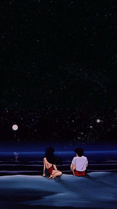 two people sitting on the beach watching the stars