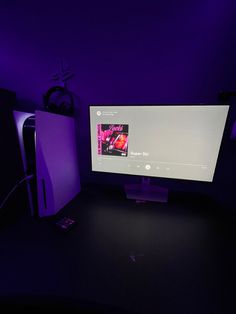 a computer monitor sitting on top of a desk next to a keyboard and mouse pad