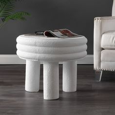 a white stool sitting on top of a hard wood floor