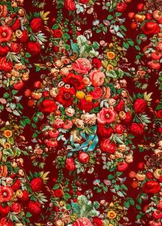 a red and green floral print fabric with flowers on the bottom, in various colors