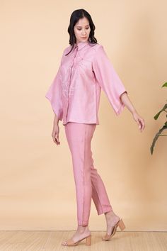 Blush pink concealed placket shirt with abstract flower embroidery. Comes with pant.
Components: 2
Pattern: Embroidery
Type Of Work: Flower
Neckline: Collar
Sleeve Type: Bell
Fabric: All weather pure silk
Color: Pink
Other Details: 
Hand-spun and handwoven
Weight (in kgs): 0.8
Shirt:
Shirt collar with hidden placket
Pant:
Elasticated back with a concealed drawstring in the front
Straight silhouette
Ankle length
Occasion: Work - Aza Fashions Elegant Pink Long Pants Set, Elegant Pink Sets With Long Pants, Feminine Spring Workwear Sets, Spring Formal Sets With Long Pants, Formal Spring Sets With Straight Pants, Formal Spring Sets With Long Pants, Feminine Floral Embroidered Sets For Spring, Formal Straight Pant Set For Spring, Pink Spring Workwear Sets