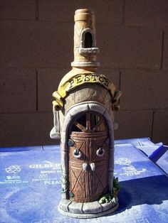 a small wooden door with a bell on top