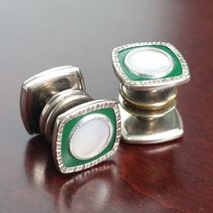 You are buying a fantastic set of vintage 1920's - 30's Snap Cufflinks! Silver Tone, double sided, and featuring a rounded square Green Celluloid front with Mother of Pearl accents. Excellent condition set, some light sign of gilt wear on the inside of one of the pieces (not seen when worn).  Great antique cufflink pair for your vintage attire! Snap Button faces are approximately 0.5" wide by tall (13mm) You will receive exact product shown. Shipped via USPS Ground Advantage with Tracking provid Vintage Hallmarked Cufflinks For Formal Occasions, Vintage Silver Wedding Cufflinks, Vintage Hallmarked Cufflinks For Formal Wear, Vintage Silver Engraved Cufflinks, Vintage Screw Back Cufflinks As Gift, Vintage Engraved Collectible Cufflinks, Vintage Screw Back Cufflinks For Anniversary, Vintage Collectible Cufflinks, Antique Cufflinks