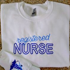 a white t - shirt with the words, registered nurse on it next to a pair of gloves