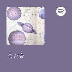 an open book with three stars on it and the image of planets in purple tones