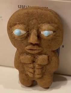 a cookie shaped like a person with blue eyes