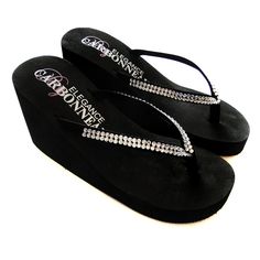 Black High Wedge Bridal Flip Flops with Crystal StrapsThese elegant black high wedge bridal flip flops feature a double row of crystals for lots of sparkle. This very popular bridal flip flop is the perfect accessory for any bride or bridesmaid looking for a comfortable yet trendy alternative to wedding shoes.Perfect for destination weddings!Many brides and bridesmaids are choosing to change into them at the reception for a comfortable way to dance without their gown dragging on the floor.The fl Bridal Clothes, High Heel Flip Flops, Bridal Flip Flops, Crystals Wedding, Crystals Black, Heeled Flip Flops, Wedge Flip Flops, Rubber Sandals, High Wedges