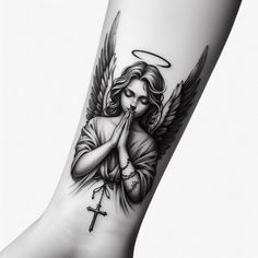 a woman with an angel tattoo on her arm holding a rosary and praying to the cross