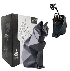 a black cat figurine next to a box with an origami design on it