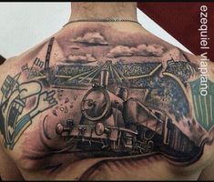 a man's back with a train tattoo on it