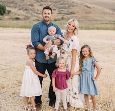 a family posing for a photo in a field