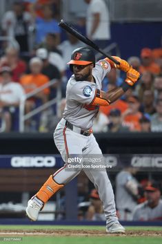 a baseball player holding a bat on top of a field in front of an audience