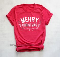 **PLACE ORDERS BEFORE 12/19/2019 WITH PRIORITY MAIL TO RECEIVE BEFORE CHRISTMAS**Please read full description.  This super soft cotton shirt is available on either a Unisex crewneck or Junior Fit Women's crewneck.  This is not an actual maternity cut shirt, so it is suggested to order the UNISEX style of shirt which runs longer in length making it a great for maternity wear, the Unisex tee is also true to size and preshrunk.  The Junior Fit Women's crewneck runs small (think 2 sizes small when not pregnant) and fitted with shorter sleeve.  See all shirt details in the size chart in the photos.   (Pictured in Heather Red Unisex Tee, Pregnant Model in photo is 5'8", 20 weeks, wearing Unisex size Small) WANT THIS ON A SWEATSHIRT INSTEAD?  FIND IT HERE: https://www.etsy.com/listing/659193561/c Christmas Pregnancy Announcement Shirt, Christmas Maternity Shirt, Christmas Maternity, Halloween Pregnancy Shirt, Pregnant Shirt, Fall Pregnancy Announcement, Halloween Pregnancy Announcement, Not Pregnant, Baby Announcement Shirts