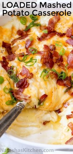 loaded mashed potato casserole with bacon and green onions in a white dish