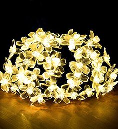 a white flower headband with lights on it