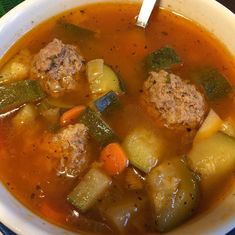 a bowl of soup with meatballs and vegetables