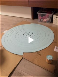 the floor is being constructed with cardboard and tape to make a circular design on it