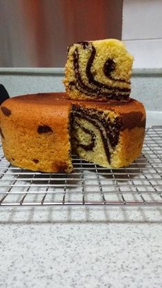 two pieces of cake sitting on top of a cooling rack