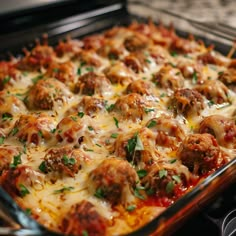 a casserole dish with meatballs and cheese on it, ready to be eaten