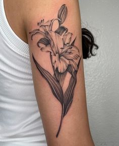 a woman with a tattoo on her arm has a flower in the shape of a heart