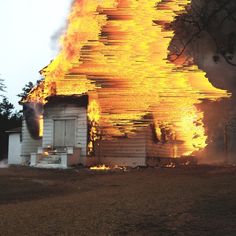 a house on fire with flames coming from it