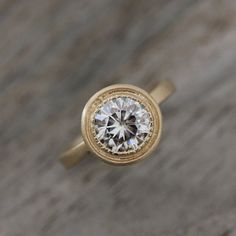 Halo Engagement Ring Moissanite Wedding Ring by onegarnetgirl, brushed gold, little bit thicker band Moissanite Engagement Ring Halo, Yellow Gold Solitaire, Diamond Alternatives, Ringe Gold, Classic Engagement Rings, Moissanite Wedding Rings, Gold Halo, Elegant Ring, Art Deco Ring