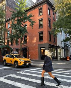 a woman standing in the middle of a cross walk