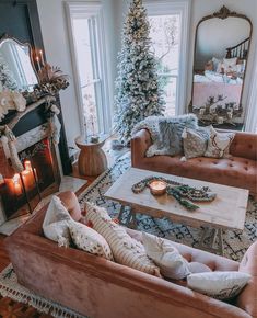 a living room filled with furniture and a christmas tree in the backround next to a fire place