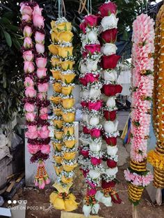 many different types of flowers hanging from hooks