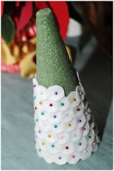 a green and white cone shaped object sitting on top of a table