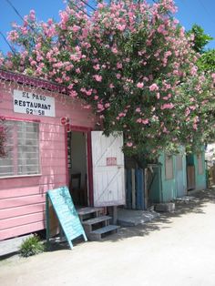 a pink building with flowers on the outside and a sign that says restarant