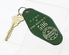 a green keychain with the number 506 on it and a white background