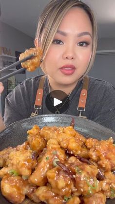 a woman holding up a fork with some food on it