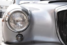 the front end of an old silver car