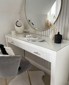 a white desk with a round mirror on it