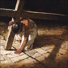 a person kneeling down on the ground with a cross in front of them and an image of jesus